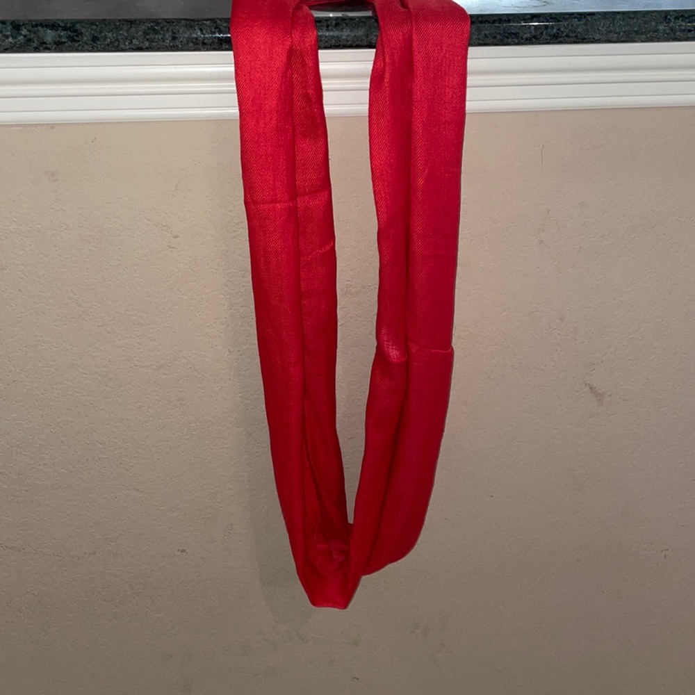 This is a classy red scarf made by Paul Smith